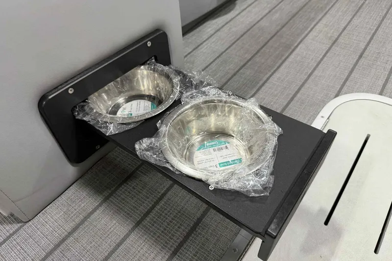 Slide: The Image of 2026 Bentley Pontoons Legacy 243 interior with dual stainless steel cup holders on a sleek surface. - 10