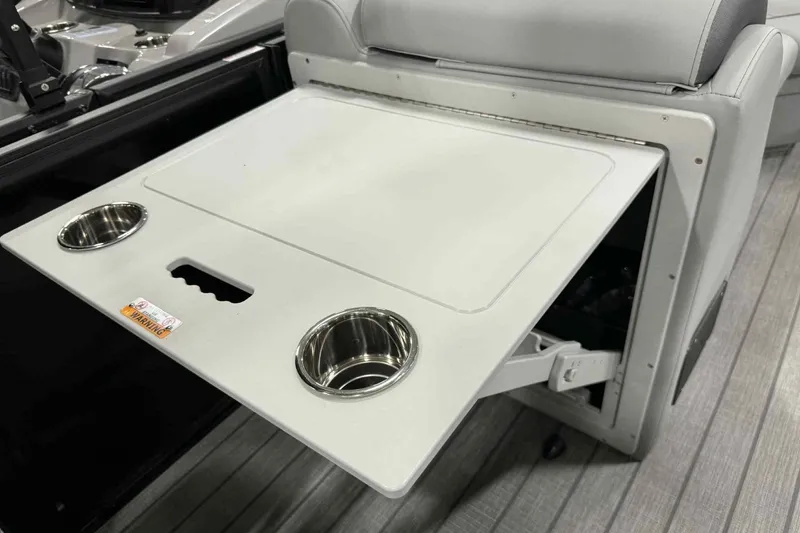 Slide: The Image of 2026 Bentley Pontoons Legacy 243 Swingback table with cup holders and warning label. - 12