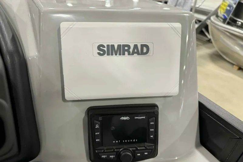 Slide: The Image of Simrad display and Wet Sounds control on 2026 Bentley Pontoons Legacy 243 dashboard. - 17