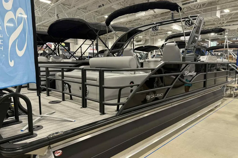 Slide: The Image of 2026 Bentley Pontoons Legacy 243 Swingback Dual Captain Full Tube Tower displayed indoors. - 3