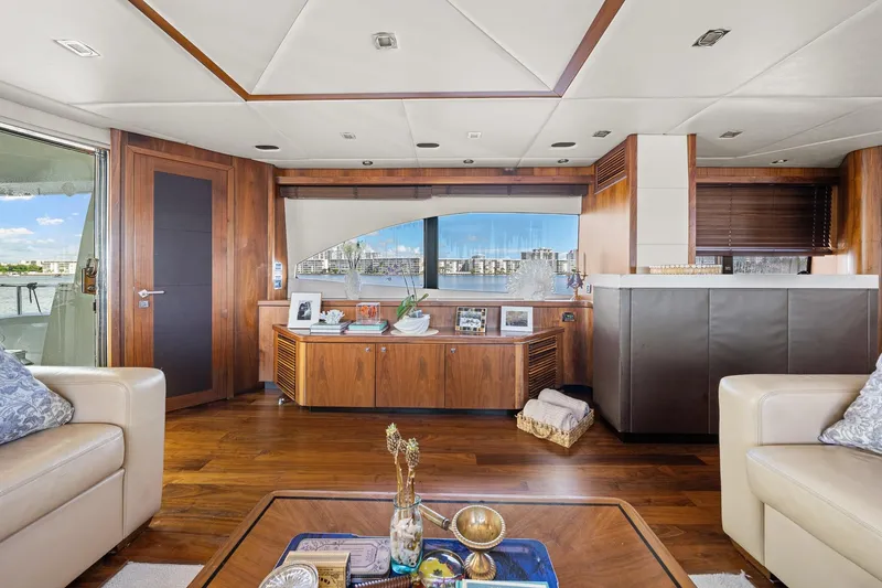 Slide: The Image of Luxurious interior of 2008 Sunseeker 90 Yacht with elegant wood finishes and waterfront view. - 100