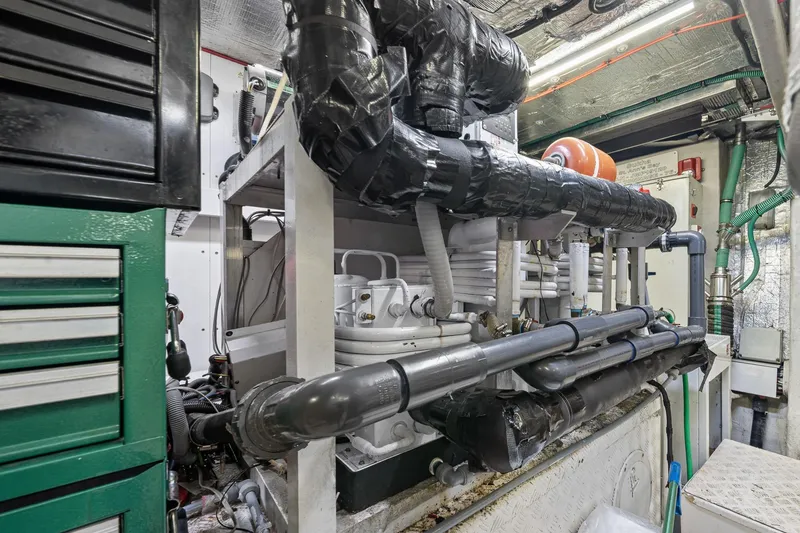 Slide: The Image of Engine room of a 2008 Sunseeker 90 Yacht, showcasing complex piping and machinery. - 107