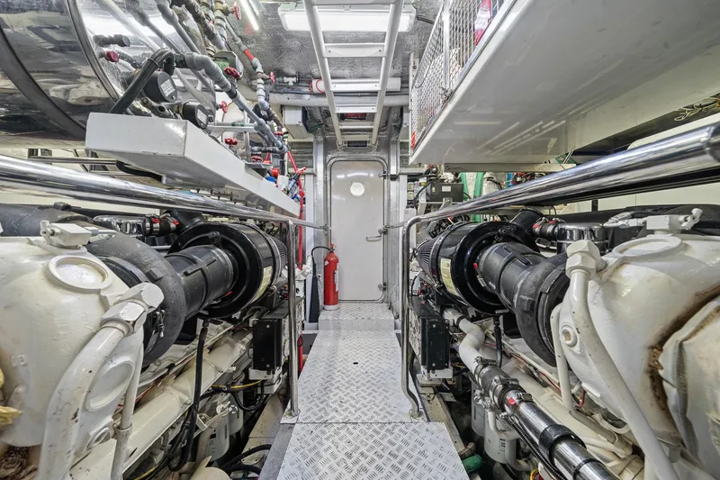 Slide: The Image of Engine room of a 2008 Sunseeker 90 Yacht, featuring complex machinery and piping. - 109