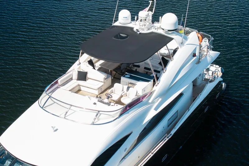 Slide: The Image of Luxurious 2008 Sunseeker 90 Yacht on calm water, featuring spacious deck and modern design. - 18