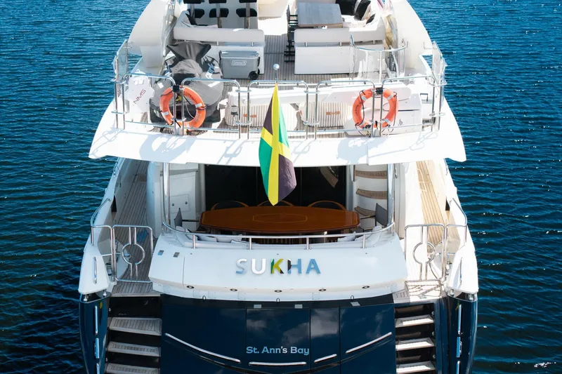 Slide: The Image of 2008 Sunseeker 90 Yacht on water, rear view with flag and lifebuoys. - 21