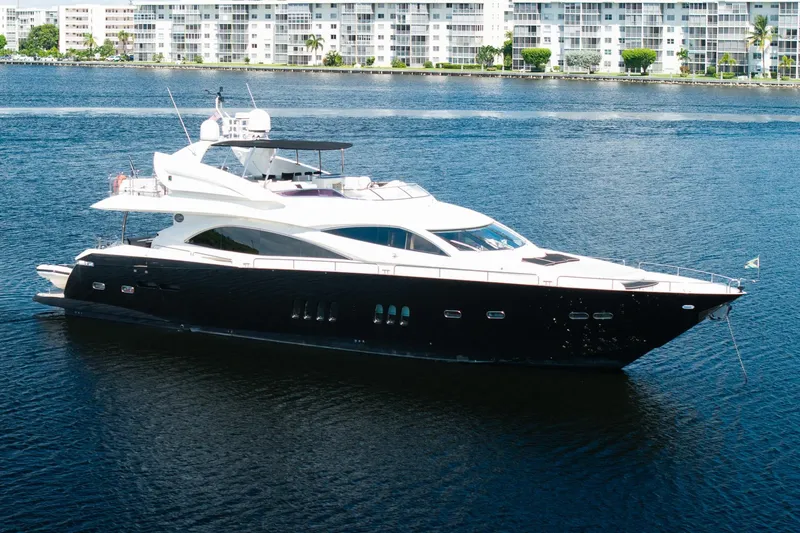 Slide: The Image of 2008 Sunseeker 90 Yacht cruising on calm waters near waterfront buildings. - 25