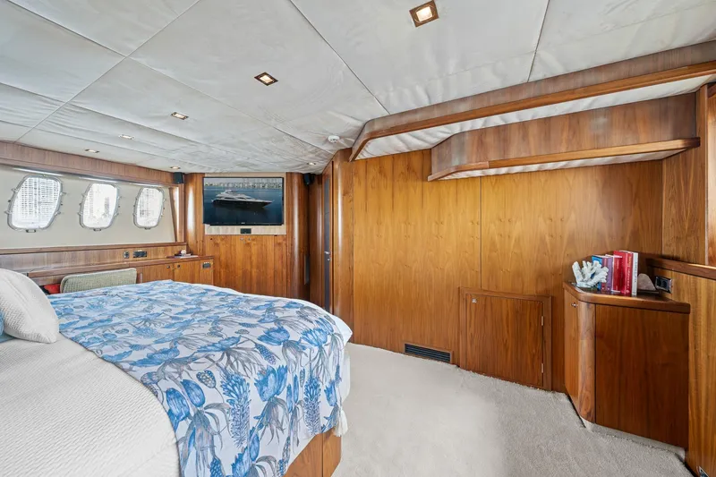 Slide: The Image of Luxurious 2008 Sunseeker 90 Yacht bedroom with wood paneling and floral bedding. - 29