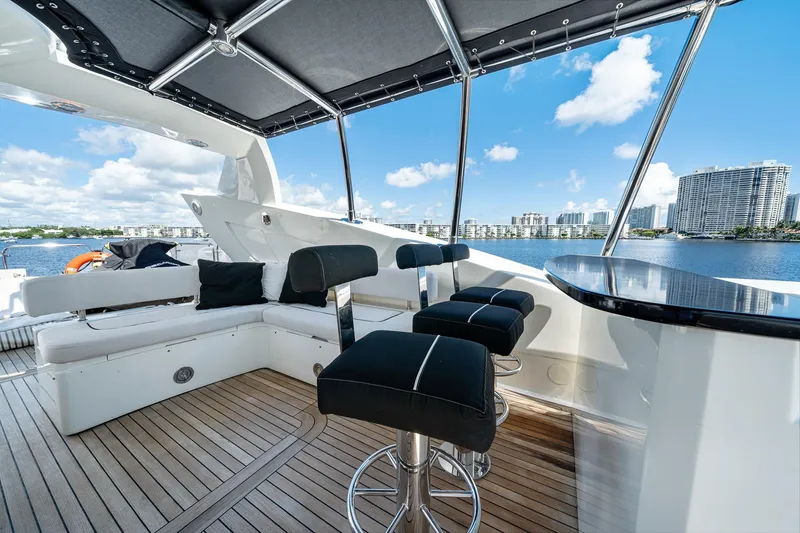 Slide: The Image of Luxurious 2008 Sunseeker 90 Yacht deck with seating, bar stools, and waterfront view. - 35