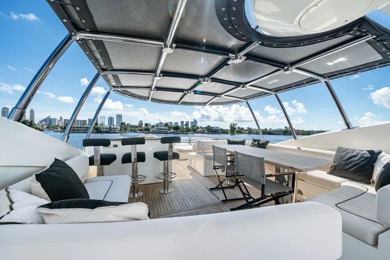 Slide: The Image of Luxurious 2008 Sunseeker 90 Yacht deck with seating, bar stools, and city skyline view. - 41