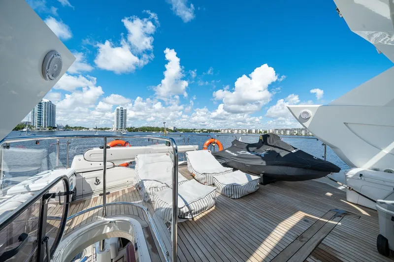 Slide: The Image of Luxurious 2008 Sunseeker 90 Yacht deck with lounge chairs and jet ski, overlooking waterfront cityscape. - 42