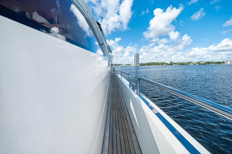 Slide: The Image of Side view of 2008 Sunseeker 90 Yacht on water, clear sky, and distant buildings. - 44