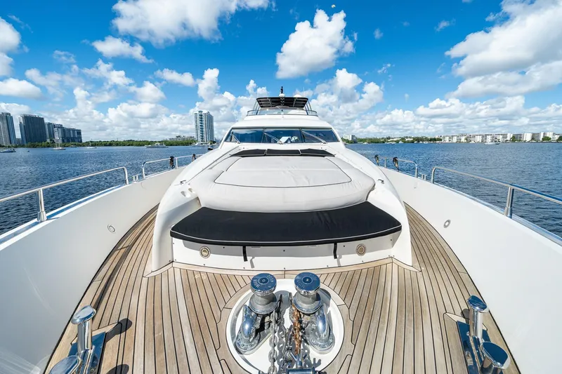 Slide: The Image of 2008 Sunseeker 90 Yacht on calm water, clear sky, cityscape background. - 48