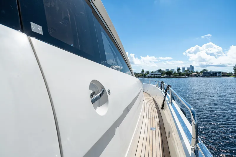 Slide: The Image of 2008 Sunseeker 90 Yacht cruising on a sunny day, showcasing sleek design and waterfront view. - 50