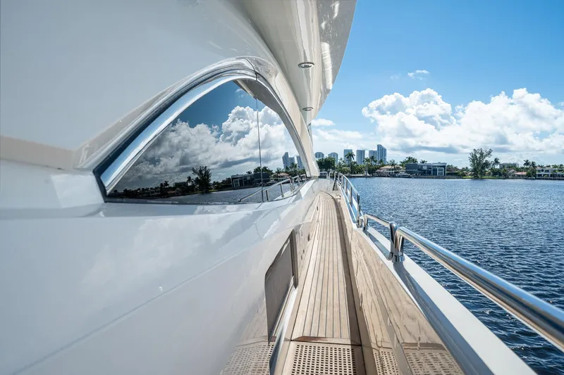 Slide: The Image of 2008 Sunseeker 90 Yacht on serene water, reflecting blue sky and clouds. - 51