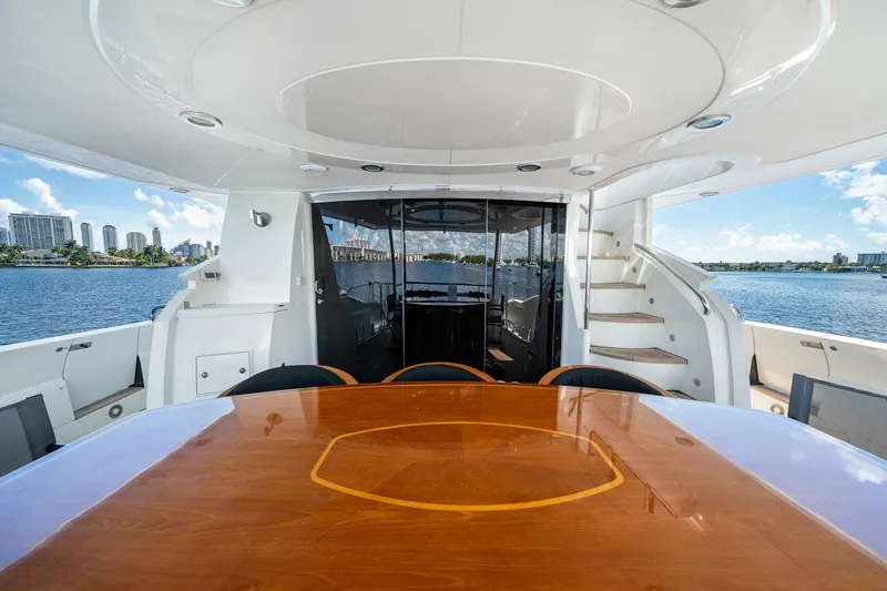 Slide: The Image of Luxurious 2008 Sunseeker 90 Yacht deck with elegant dining area and scenic waterfront view. - 52