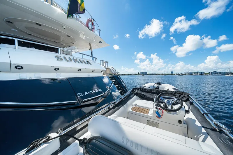 Slide: The Image of 2008 Sunseeker 90 Yacht "Sukha" docked in St. Ann's Bay, with a small boat nearby. - 54