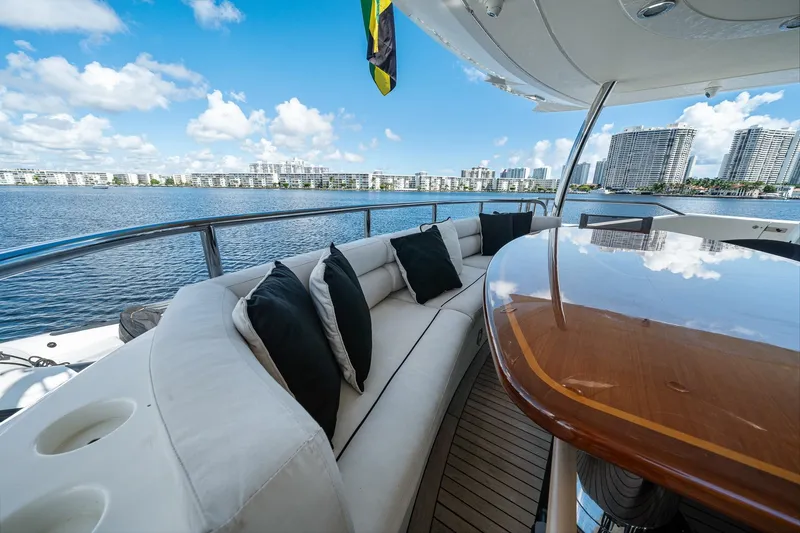 Slide: The Image of Luxurious 2008 Sunseeker 90 Yacht deck with elegant seating and scenic waterfront view. - 57