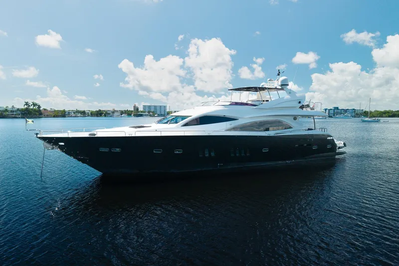 Slide: The Image of Luxury 2008 Sunseeker 90 Yacht on calm water under clear blue sky. - 6