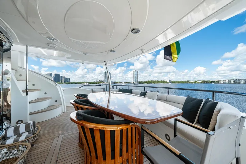 Slide: The Image of Luxurious 2008 Sunseeker 90 Yacht deck with elegant seating and scenic waterfront view. - 60