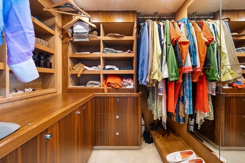 Slide: The Image of Luxurious wooden closet with colorful clothes in a 2008 Sunseeker 90 Yacht. - 69