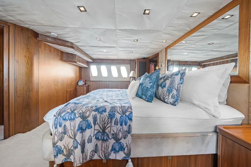 Slide: The Image of Luxurious bedroom interior of 2008 Sunseeker 90 Yacht with floral bedding and wood paneling. - 73