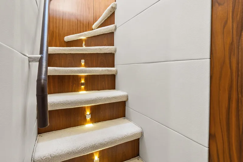 Slide: The Image of Luxurious carpeted staircase with ambient lighting on a 2008 Sunseeker 90 Yacht. - 78