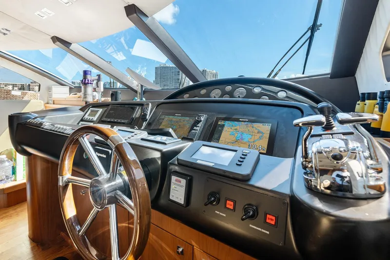 Slide: The Image of Cockpit of 2008 Sunseeker 90 Yacht with navigation equipment and steering wheel. - 79