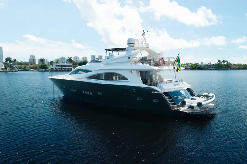 Slide: The Image of 2008 Sunseeker 90 Yacht on calm water, featuring sleek design and luxury amenities. - 8