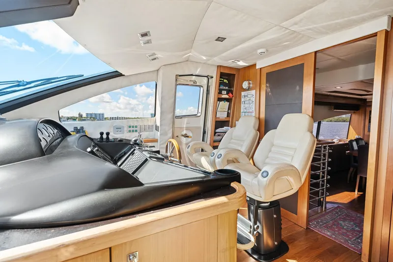 Slide: The Image of Luxurious interior of 2008 Sunseeker 90 Yacht with modern helm and plush seating. - 80