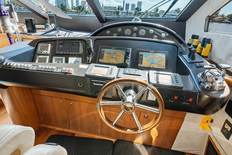 Slide: The Image of Cockpit of 2008 Sunseeker 90 Yacht with navigation controls and steering wheel. - 81