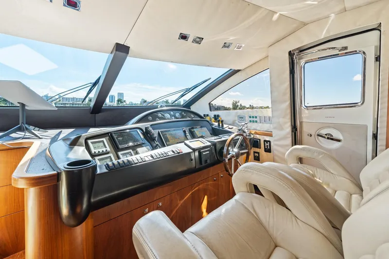 Slide: The Image of Luxurious 2008 Sunseeker 90 Yacht helm with modern controls and plush seating. - 84