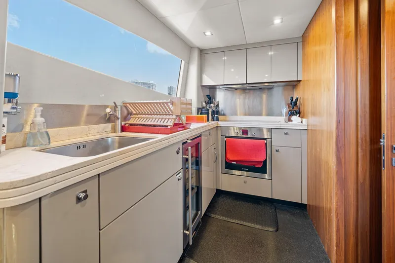 Slide: The Image of Modern kitchen interior on 2008 Sunseeker 90 Yacht, featuring sleek cabinetry and stainless steel appliances. - 85