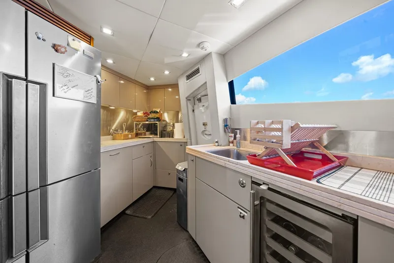Slide: The Image of Modern kitchen interior on 2008 Sunseeker 90 Yacht with stainless steel appliances and ocean view. - 86