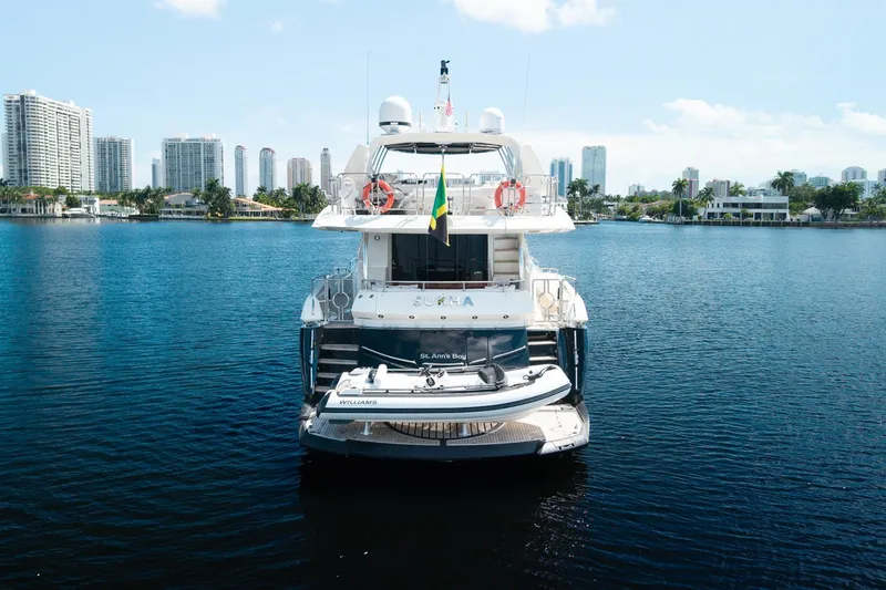 Slide: The Image of Rear view of 2008 Sunseeker 90 Yacht on calm water with city skyline. - 9