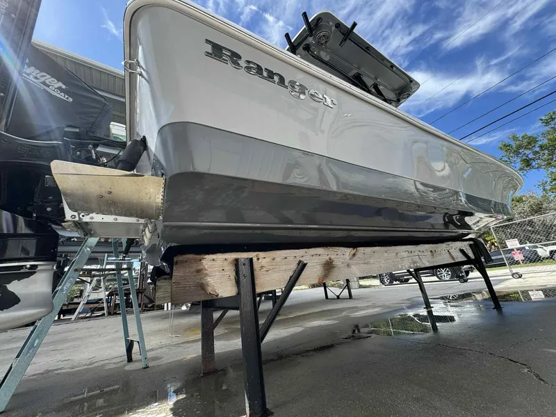 Slide: The Image of 2020 Ranger 2360 Bay boat on stands, viewed from below, outdoors. - 49