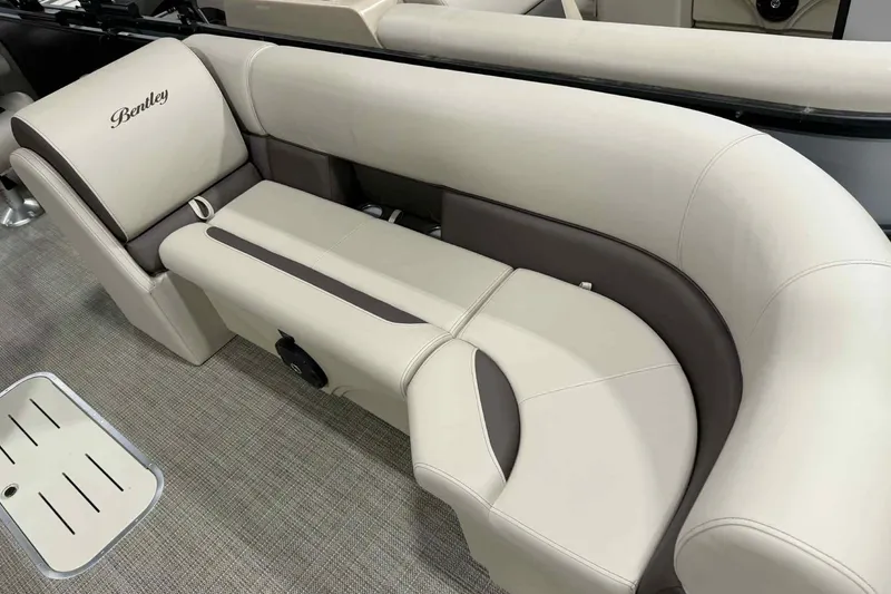 Slide: The Image of 2026 Bentley Pontoons Legacy 243 Swingback interior with beige and brown seating. - 2