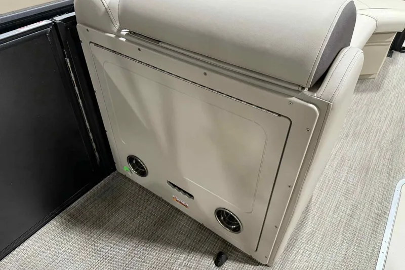 Slide: The Image of 2026 Bentley Pontoons Legacy 243 Swingback interior seating detail, featuring beige upholstery and storage compartment. - 4