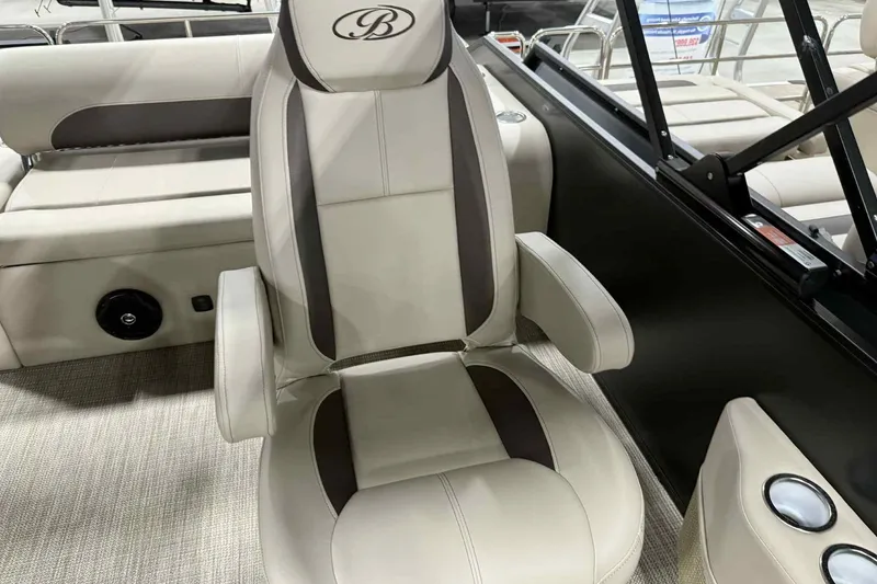 Slide: The Image of 2026 Bentley Pontoons Legacy 243 Swingback captain's chair, beige and brown upholstery, luxurious design. - 6