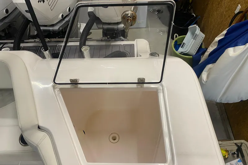 Slide: The Image of Open storage compartment on 2022 Front Runner 39 CC boat, featuring a transparent lid. - 11