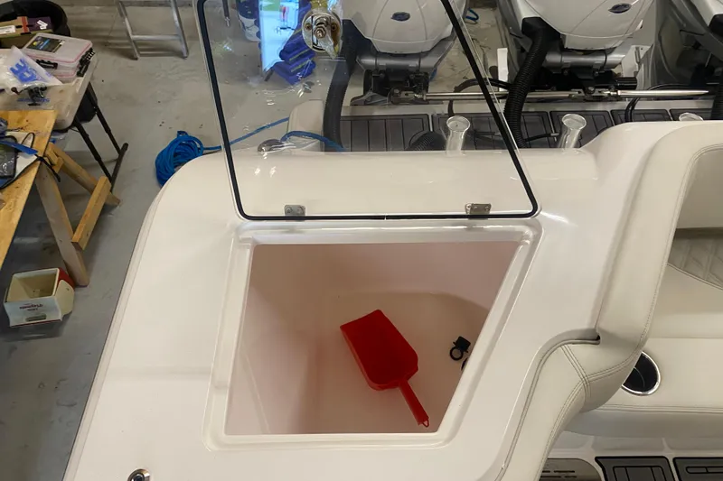 Slide: The Image of 2022 Front Runner 39 CC boat storage compartment with red scoop and accessories. - 12
