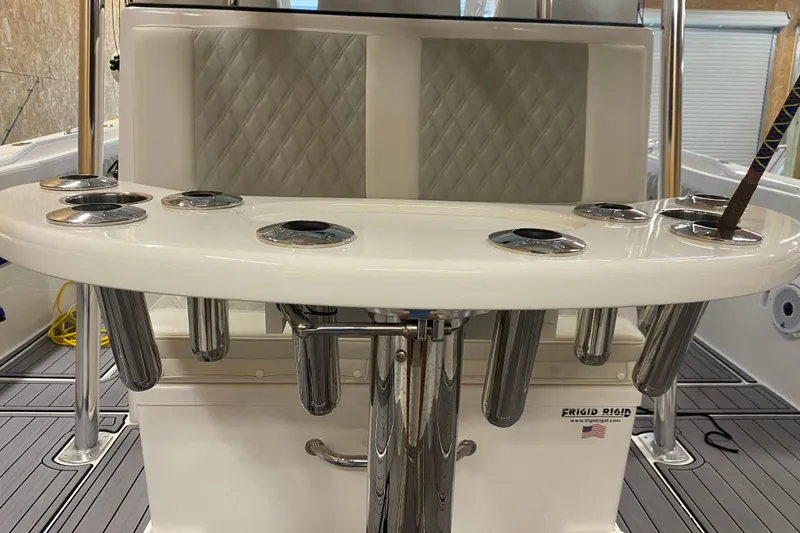 Slide: The Image of 2022 Front Runner 39 CC boat interior with rod holders and cushioned seating. - 13