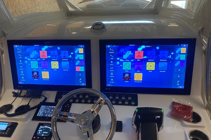 Slide: The Image of 2022 Front Runner 39 CC boat dashboard with dual Simrad displays and modern controls. - 18