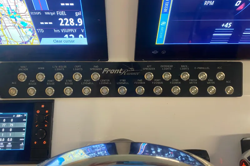 Slide: The Image of Control panel of a 2022 Front Runner 39 CC boat with navigation and system switches. - 19