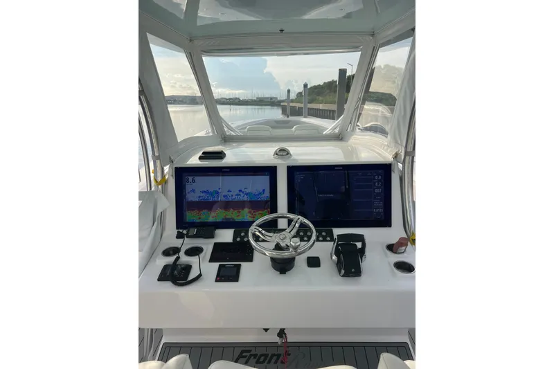 Slide: The Image of 2022 Front Runner 39 CC boat helm with dual screens and steering wheel. - 20