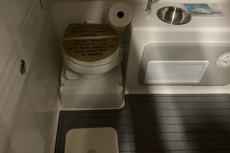 Slide: The Image of 2022 Front Runner 39 CC boat bathroom with toilet, sink, and protective film. - 38