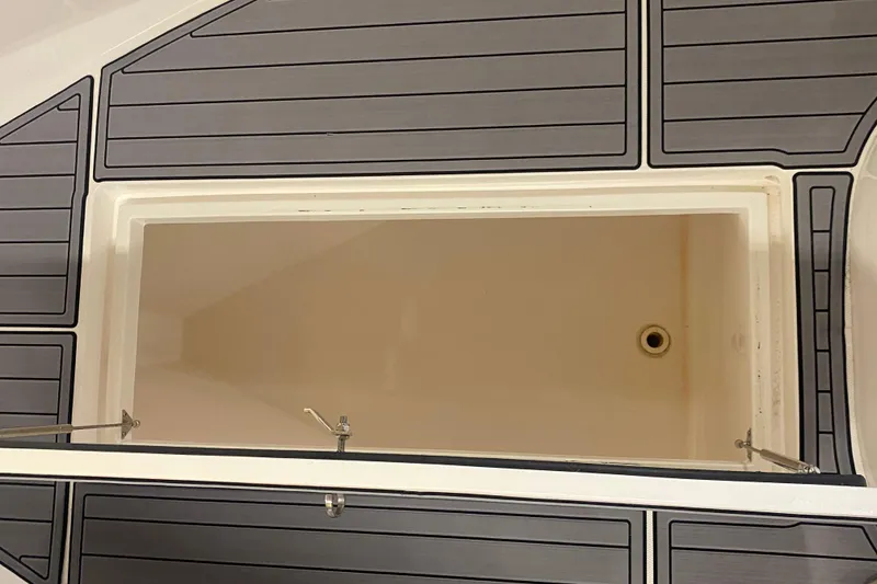 Slide: The Image of Open storage compartment on 2022 Front Runner 39 CC boat with gray paneling. - 48