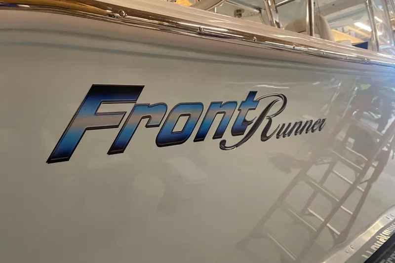 Slide: The Image of 2022 Front Runner 39 CC boat logo on sleek hull surface. - 49