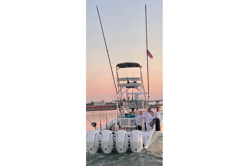 Slide: The Image of 2022 Front Runner 39 CC boat with multiple outboard engines at sunset. - 50