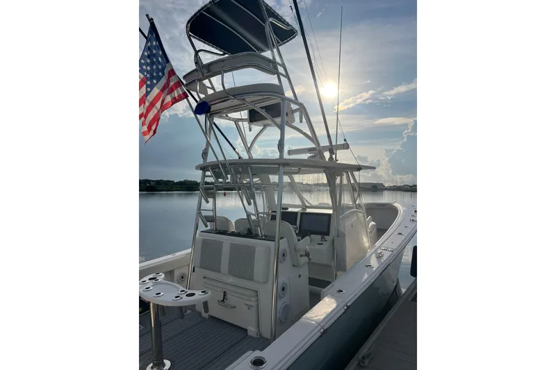 Slide: The Image of 2022 Front Runner 39 CC boat with American flag, docked at sunset. - 6