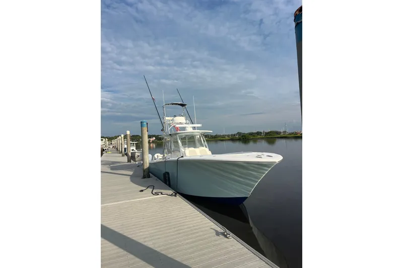 Slide: The Image of 2022 Front Runner 39 CC boat docked at a marina under a cloudy sky. - 7